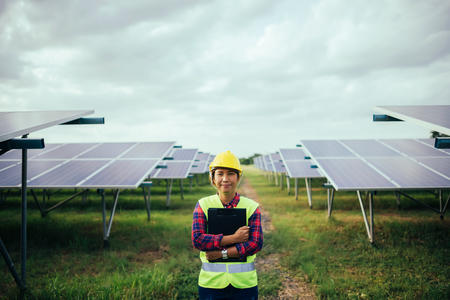 Person standing in front of solar panels