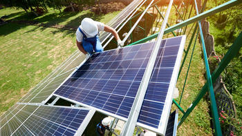 worker on solar panels